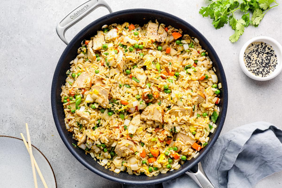 A skillet filled with chicken fried rice.