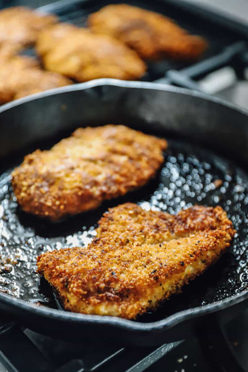frying chicken parm in a skillet
