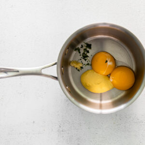 ingredients for hollandaise sauce in a saucepan.
