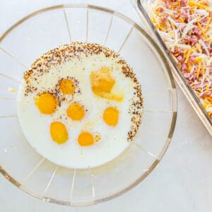 eggs milk and seasoning in a glass bowl.
