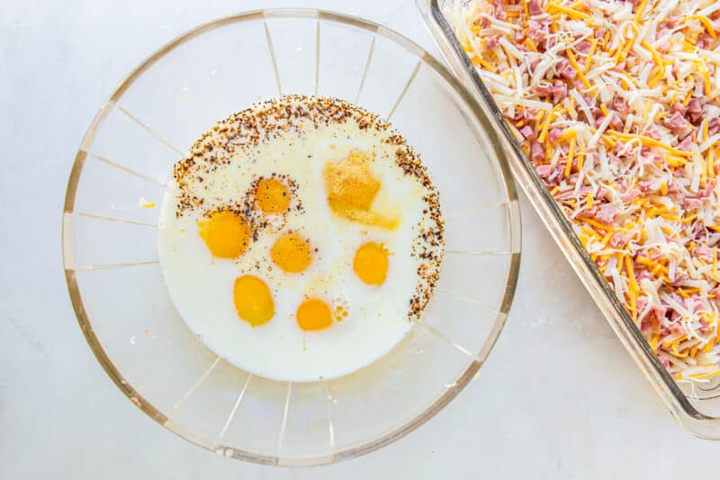 eggs milk and seasoning in a glass bowl.