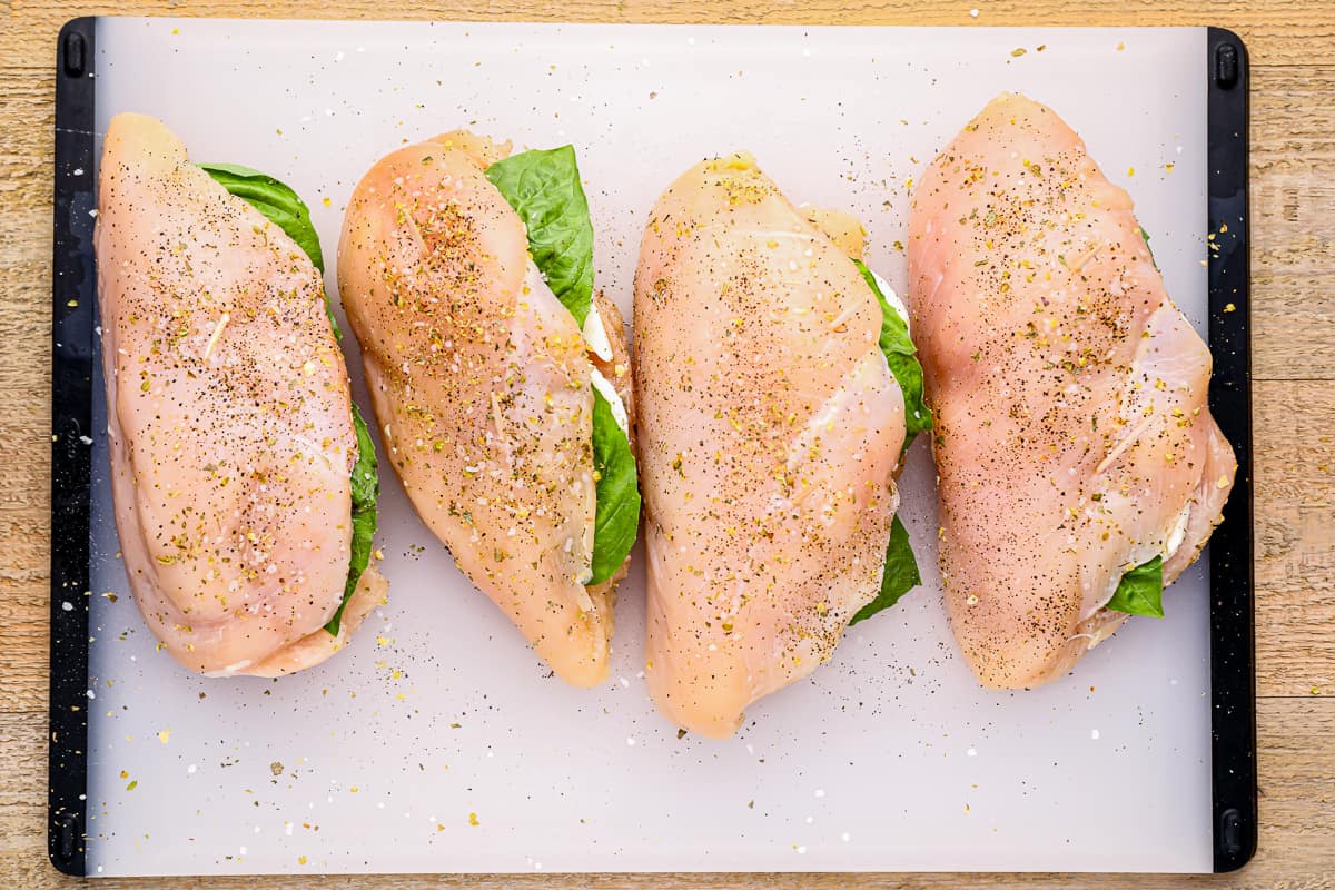 4 mozzarella stuffed chicken breasts seasoned with salt and pepper.