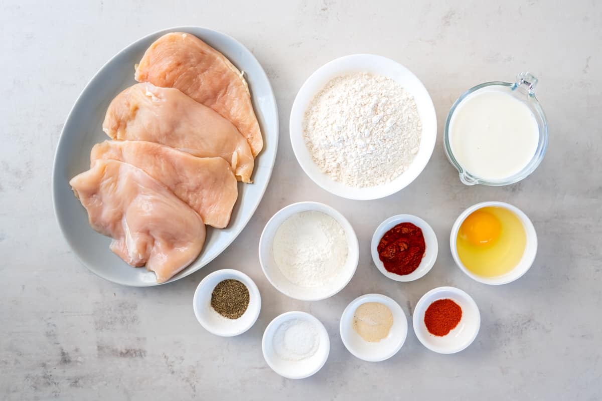ingredients for country fried chicken arranged in bowls