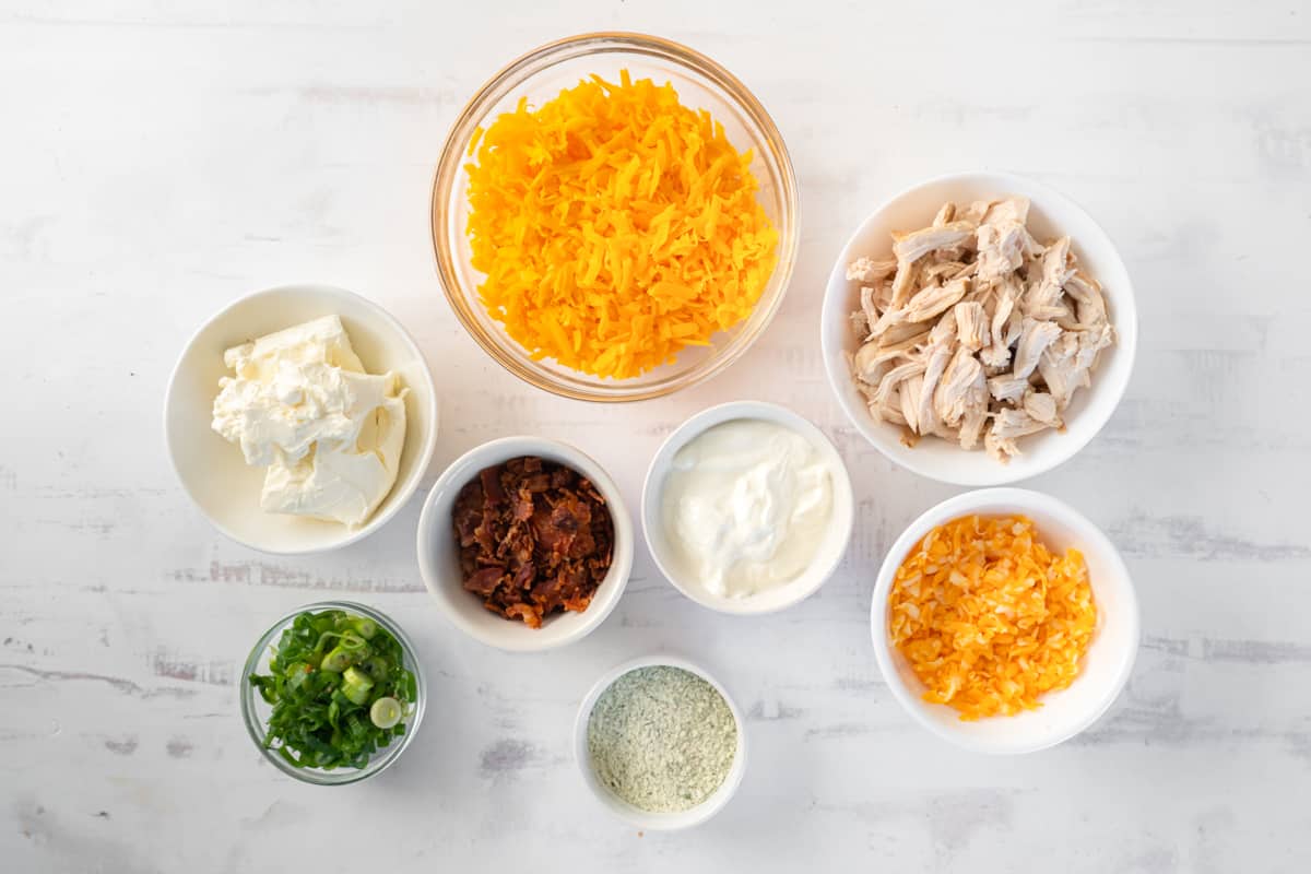 small bowls filled with ingredients for creamy crack chicken dip.