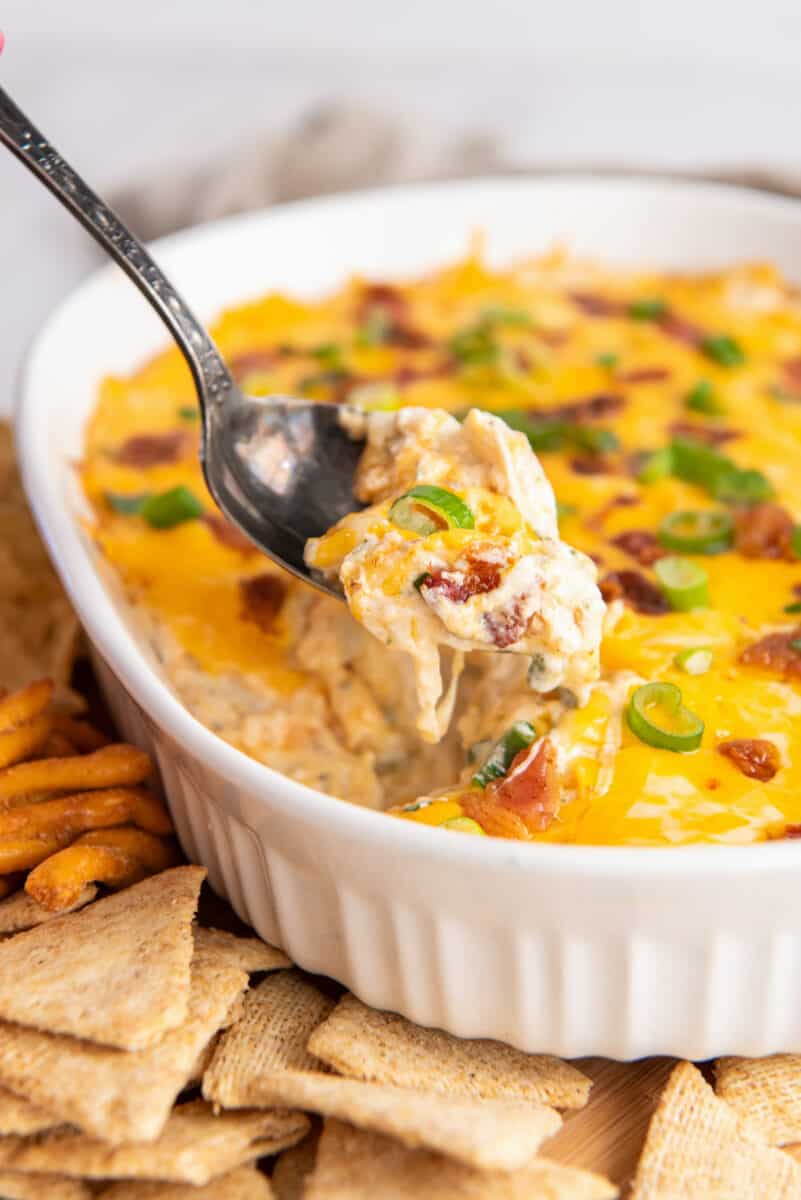 a spoon dipping into a dish of crack chicken dip