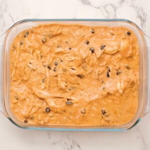 chicken enchilada dip in a glass baking pan.