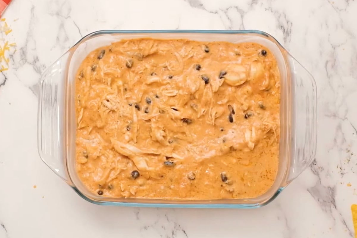 chicken enchilada dip in a glass baking pan.