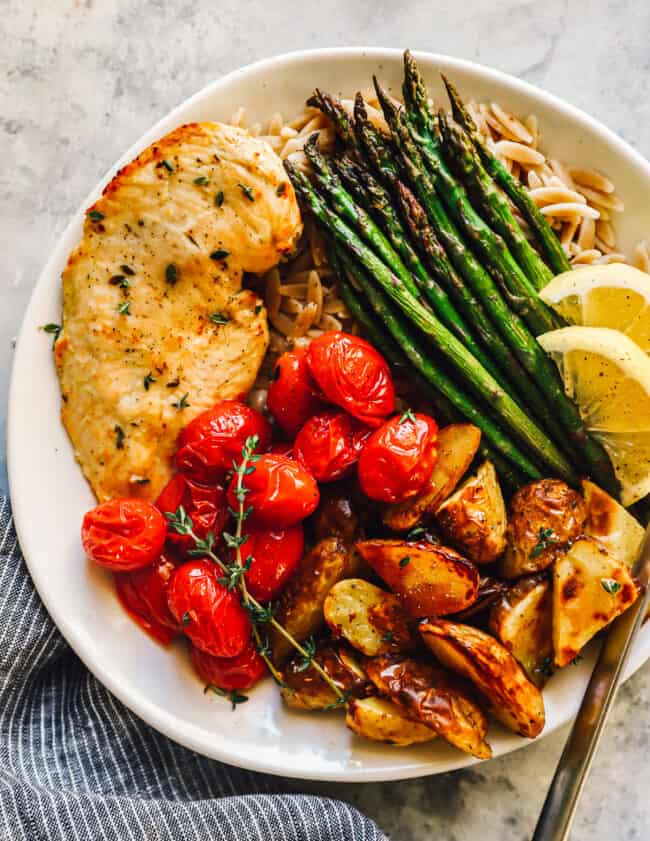 healthy sheet pan chicken dinner on a plate