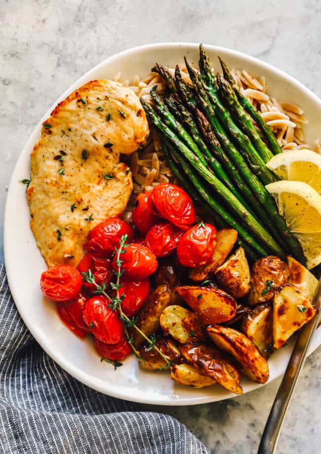 healthy sheet pan chicken dinner on a plate