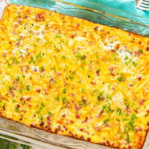 overhead view of a baked ham and cheese breakfast casserole in a glass baking pan.