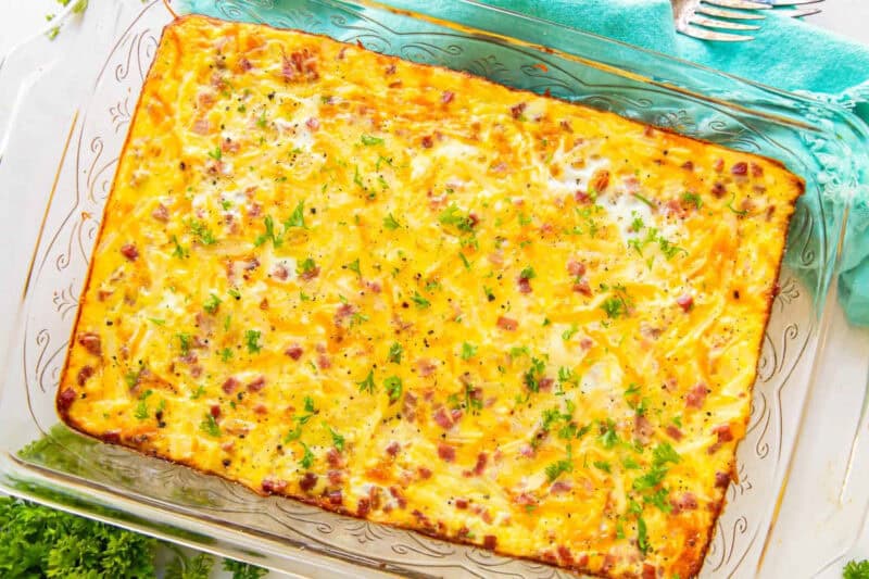 overhead view of a baked ham and cheese breakfast casserole in a glass baking pan.