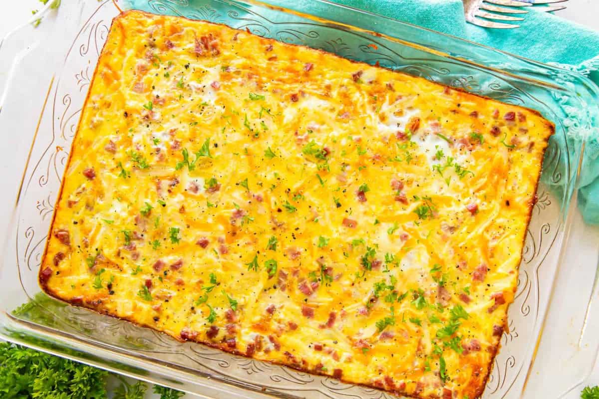overhead view of a baked ham and cheese breakfast casserole in a glass baking pan.