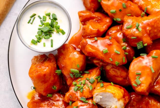 a plate of boneless wings with buffalo sauce