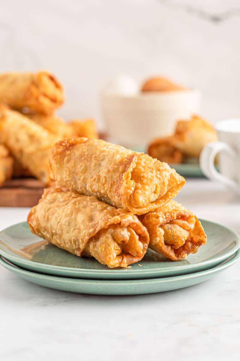 breakfast egg rolls stacked on a plate