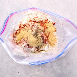 flour and seasonings mixed inside of a resealable plastic bag