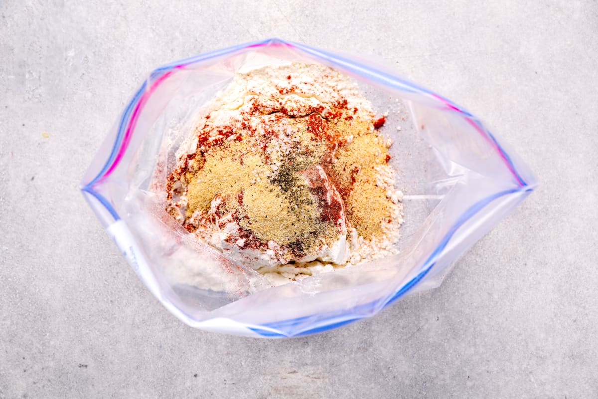 flour and seasonings mixed inside of a resealable plastic bag