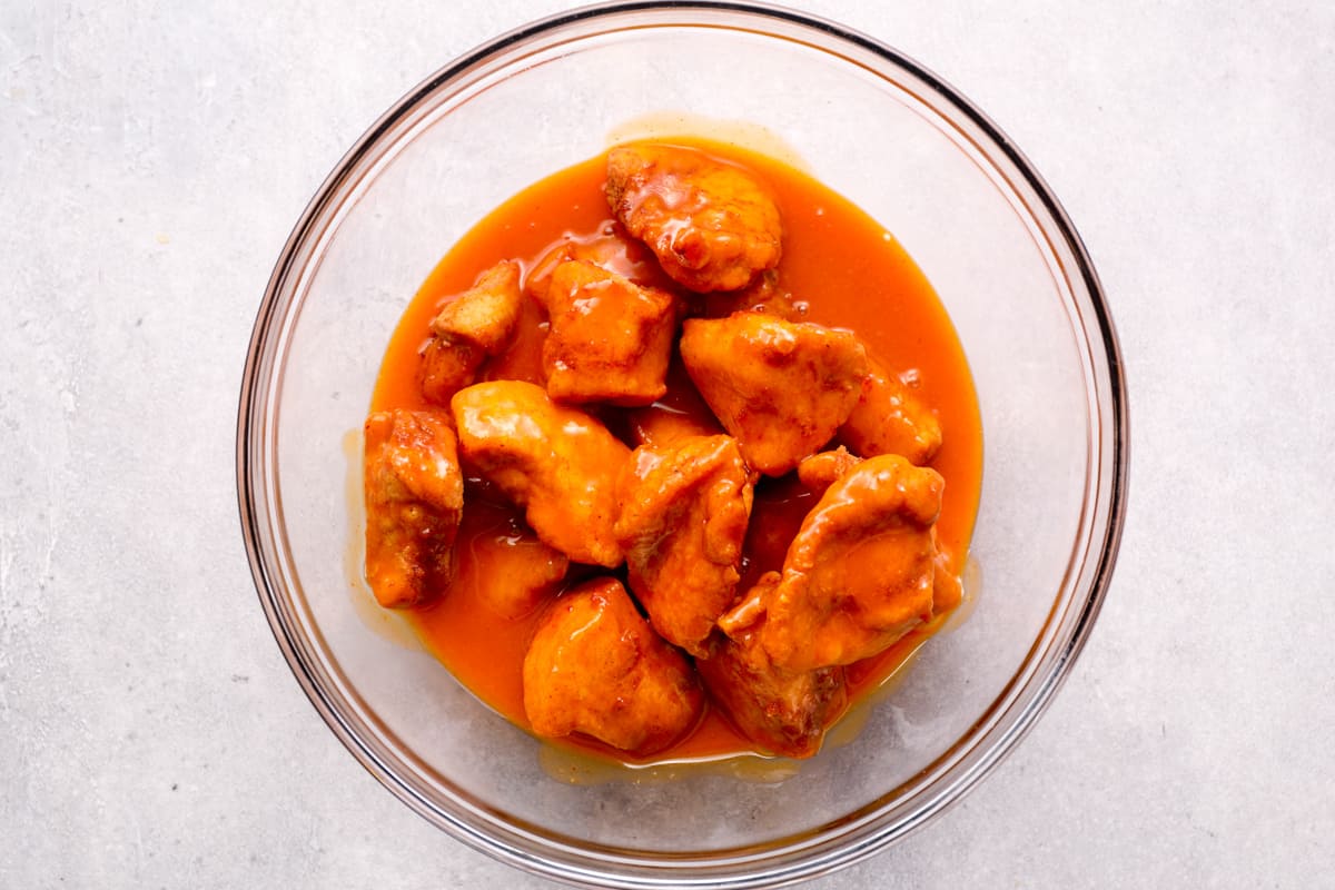 boneless wings soaking in buffalo sauce