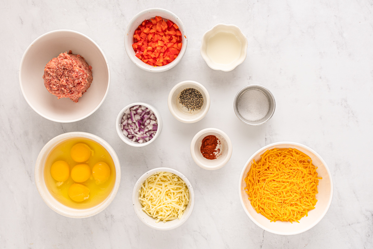Ingredients for breakfast egg rolls arranged in bowls.