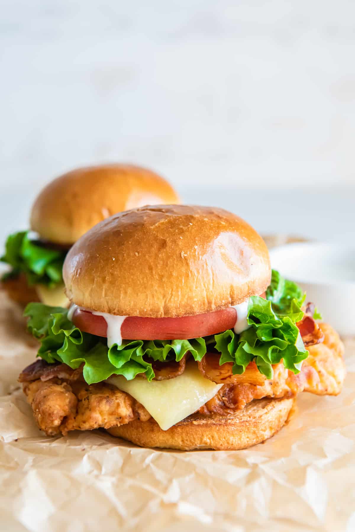 asiago ranch chicken club sandwich with cheese, lettuce, and tomato