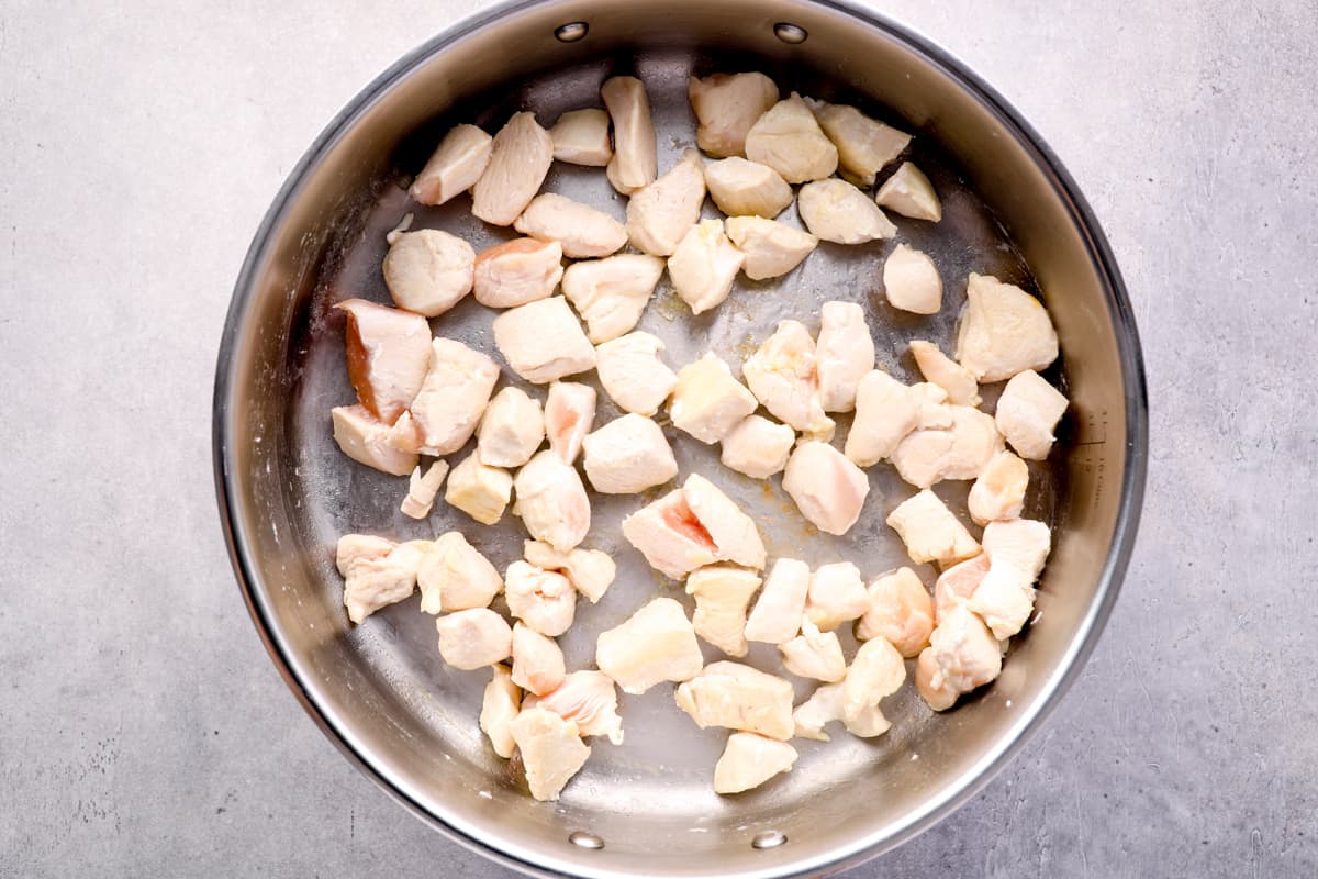 cooking cubes of chicken