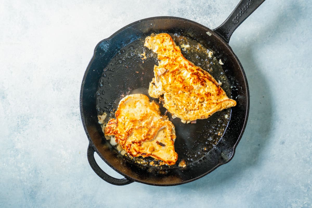 frying chicken in a skillet