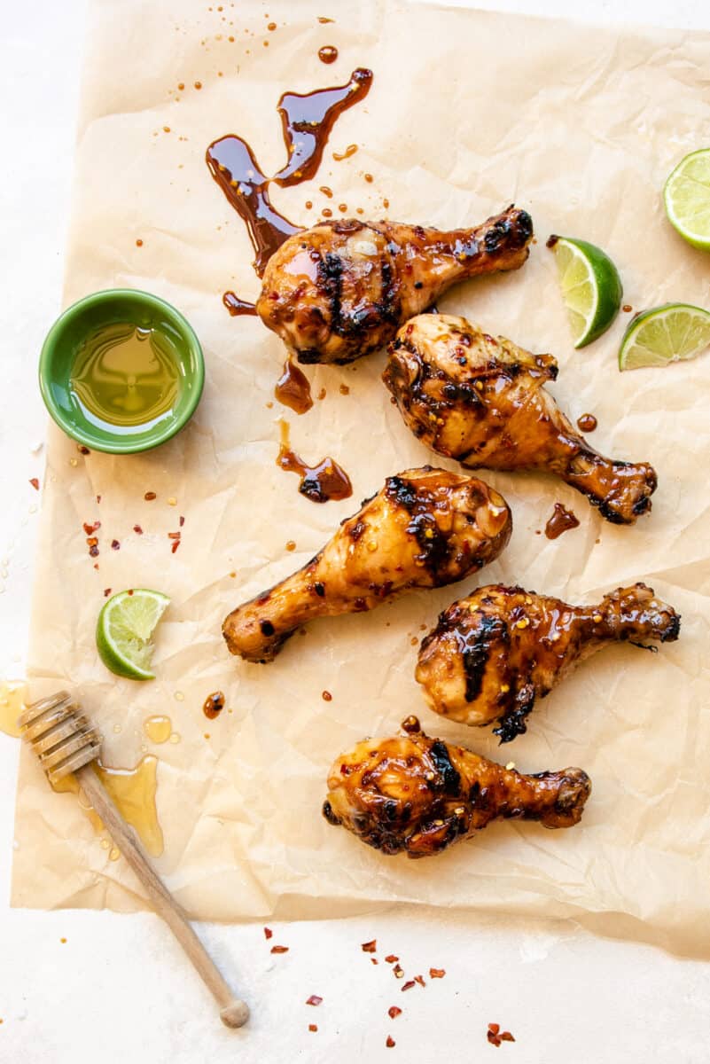 grilled honey lime chicken drumsticks on parchment paper