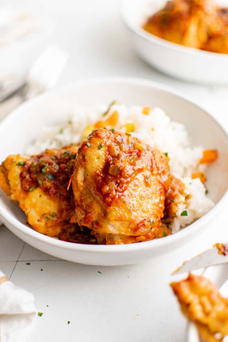harissa chicken thighs in a bowl of rice