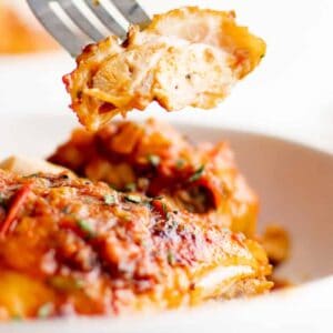 fork picking up a piece of harissa chicken