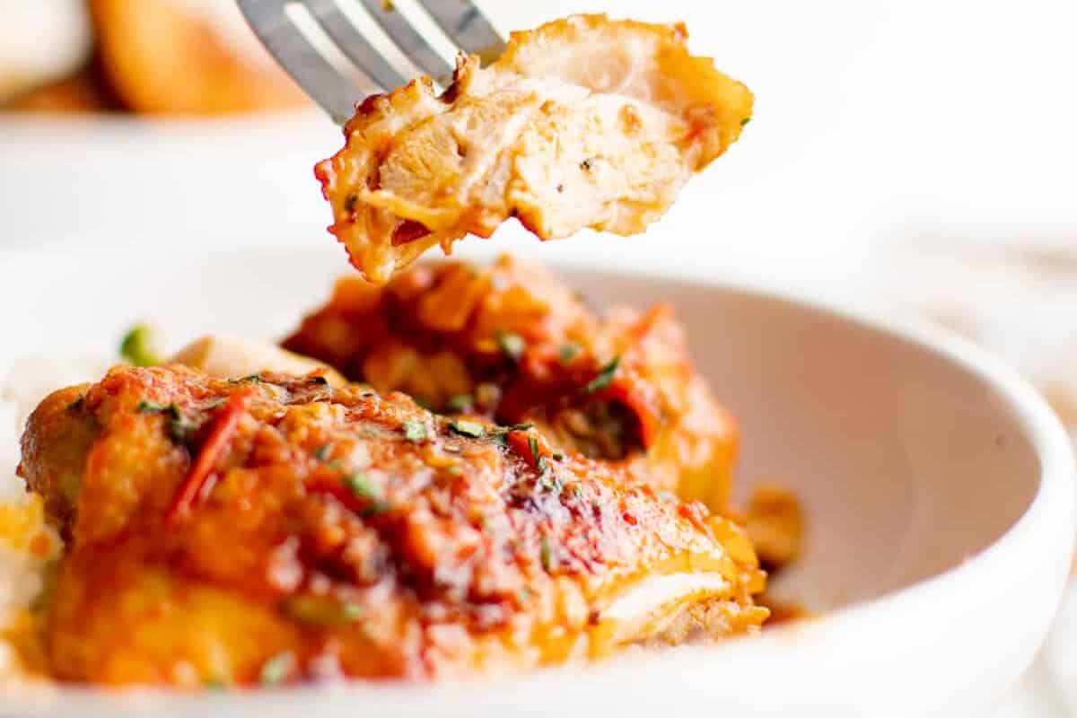 fork picking up a piece of harissa chicken