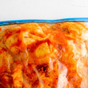 chicken thighs coated in harissa in a resealable bag