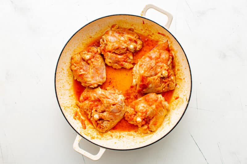 seasoned chicken thighs in a pot