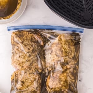 chicken thighs marinating in a resealable bag