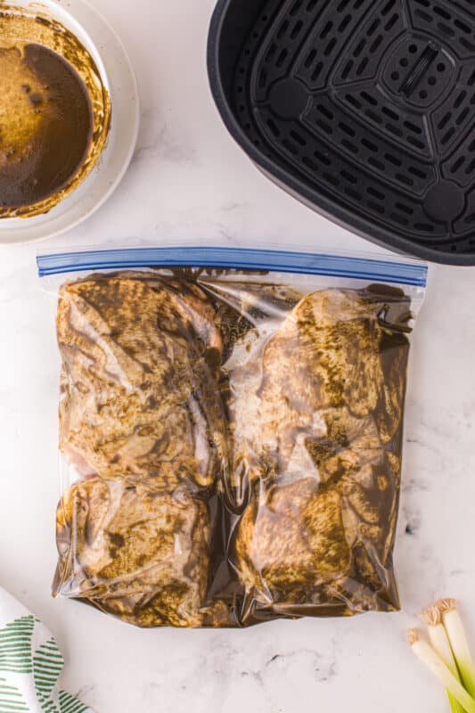 chicken thighs marinating in a resealable bag