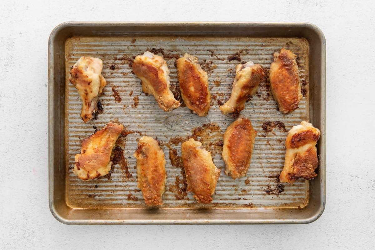 Baked chicken wings on a tray.