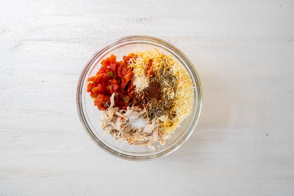 Chicken taquito filling in a mixing bowl.