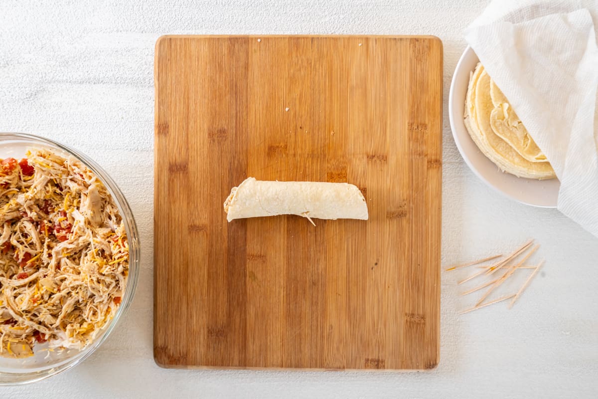 Rolled taco on a cutting board.