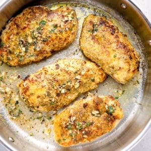 crispy chicken breast frying in a skillet