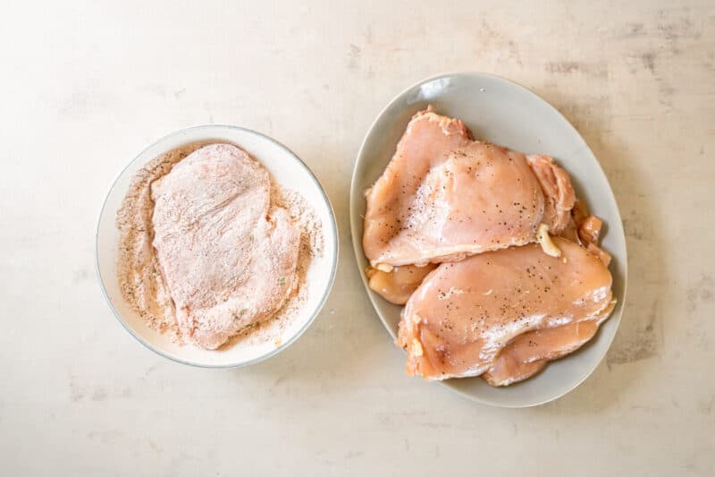 dredging chicken breasts in a flour coating