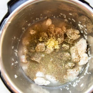 chicken and seasonings in a pressure cooker