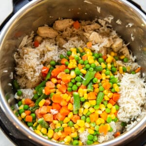 chicken, rice, corn, carrots, peas, and green beans in a pressure cooker
