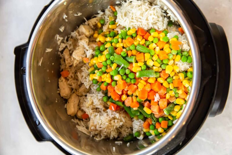 chicken, rice, corn, carrots, peas, and green beans in a pressure cooker