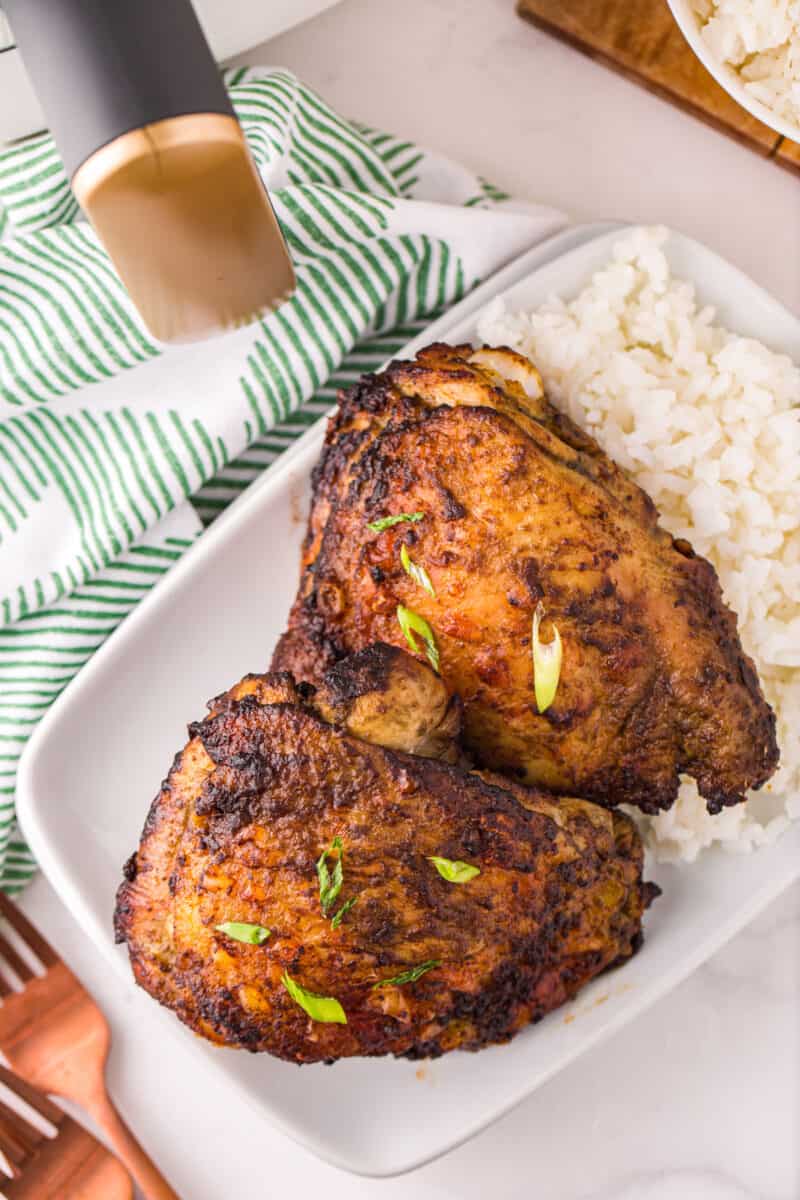 lemongrass chicken thighs on a plate with white rice