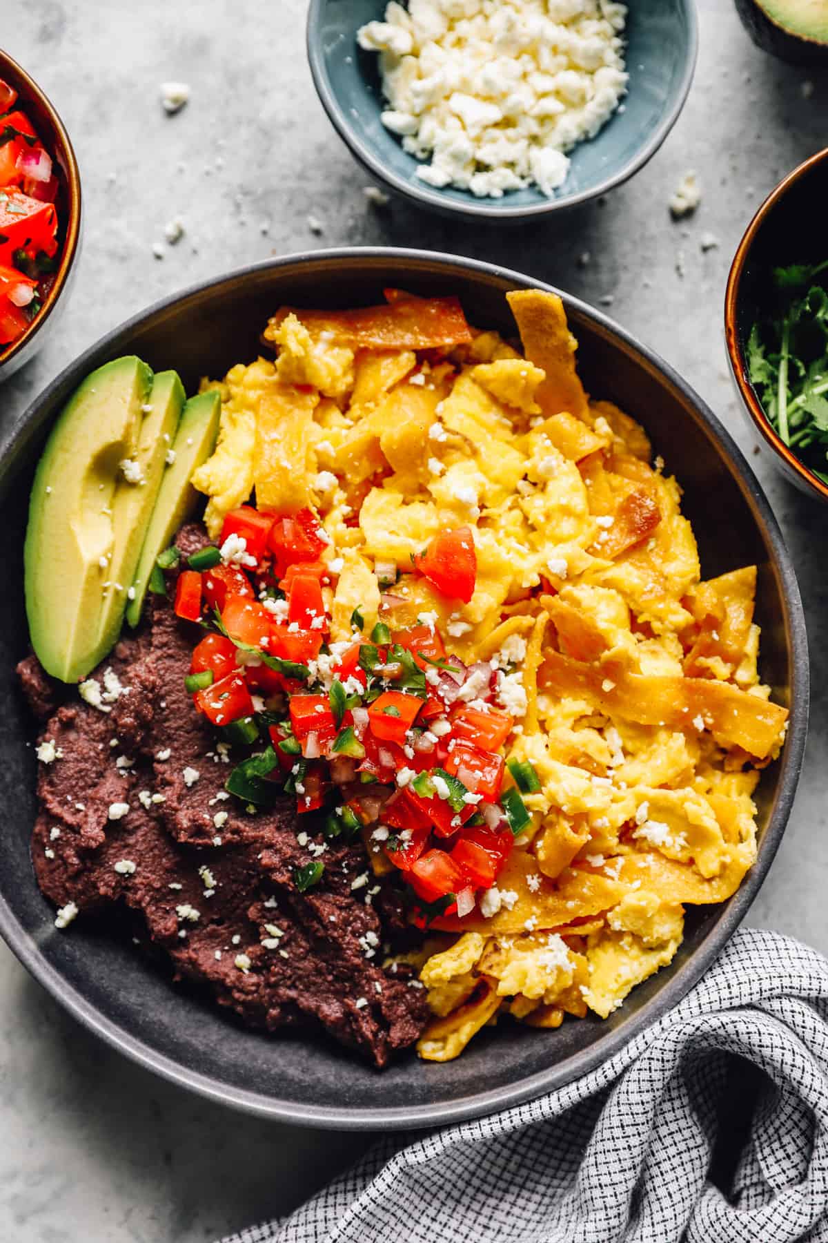 a bowl of Migas and refried beans