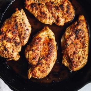 chicken breasts cooking in a pan