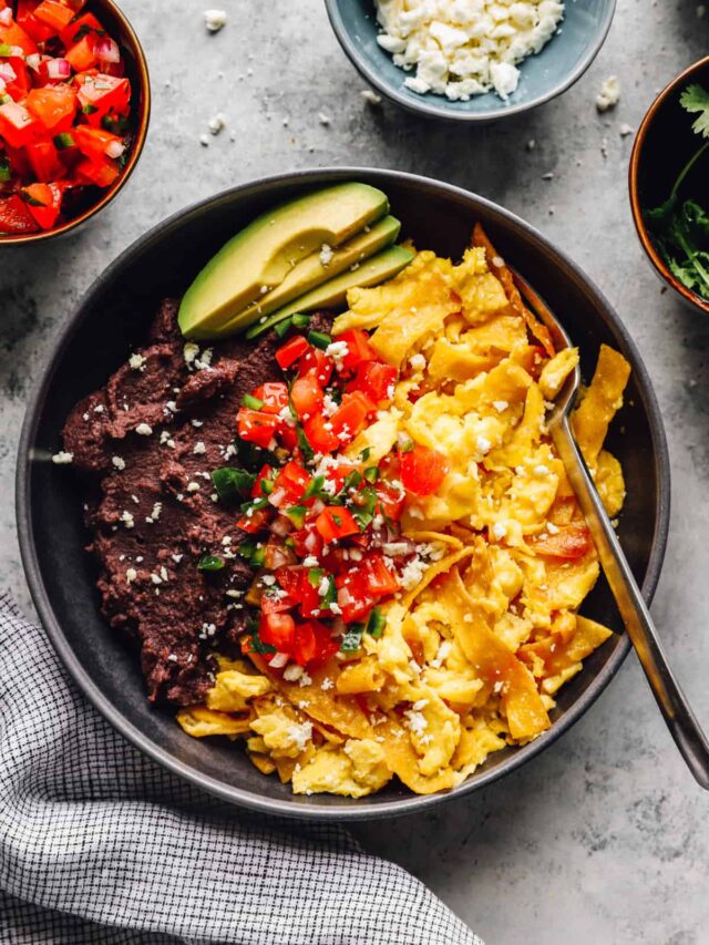 migas served in a bowl with refried black beans, avocado slices, and pico de Gallo