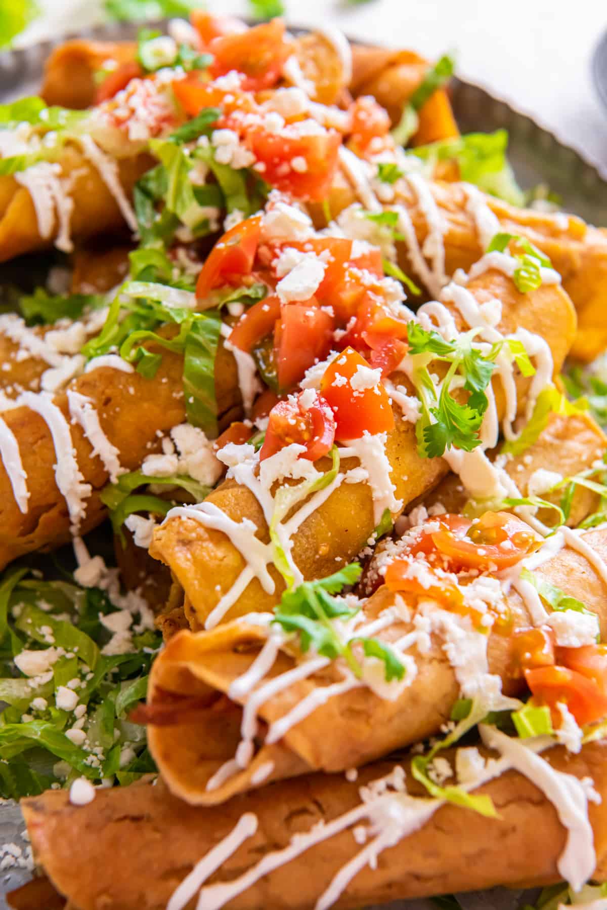 A platter of fried Chicken Taquitos.