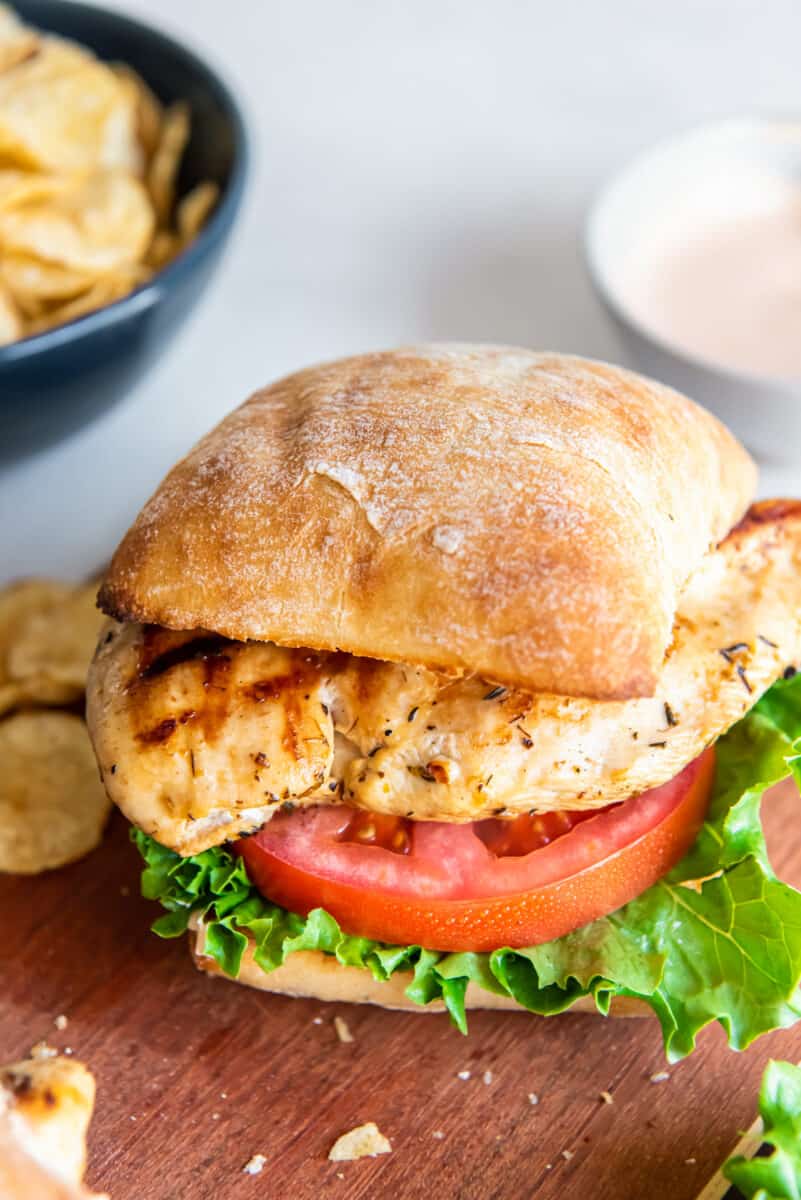 a grilled chicken sandwich with tomato and lettuce