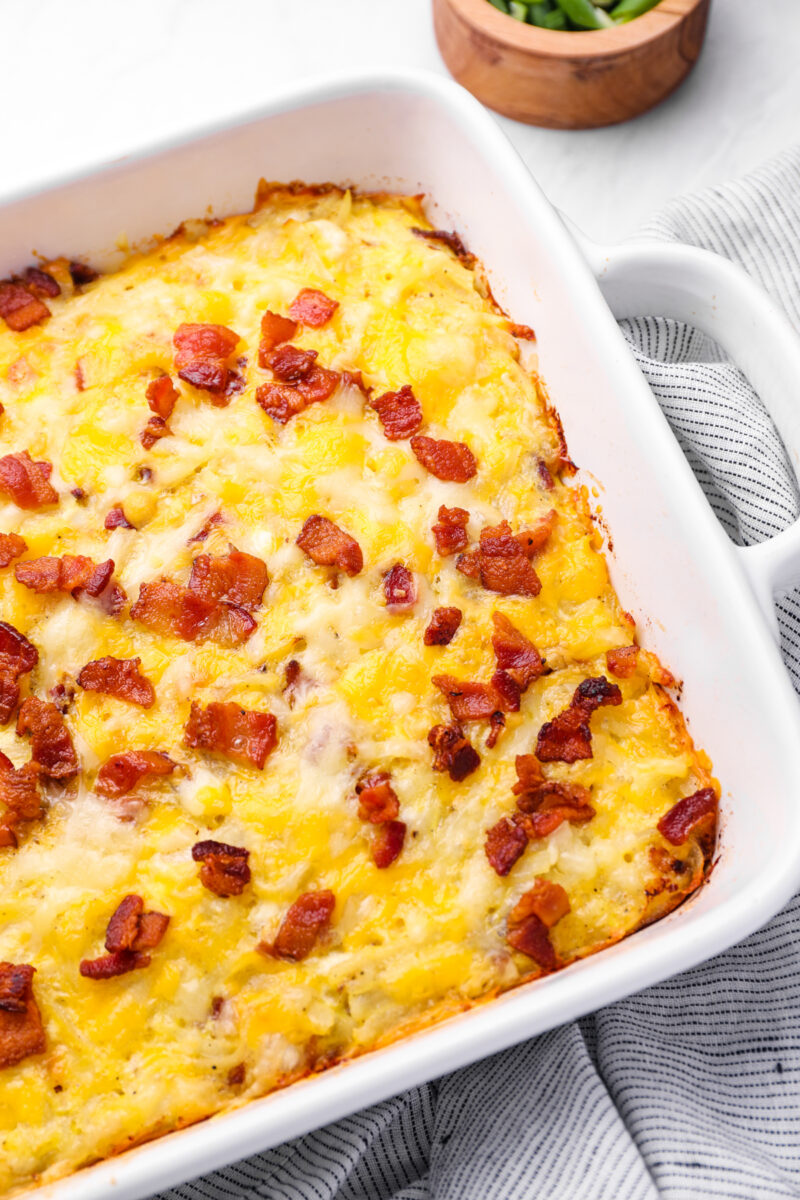 cheesy amish breakfast casserole with bacon in a white casserole dish