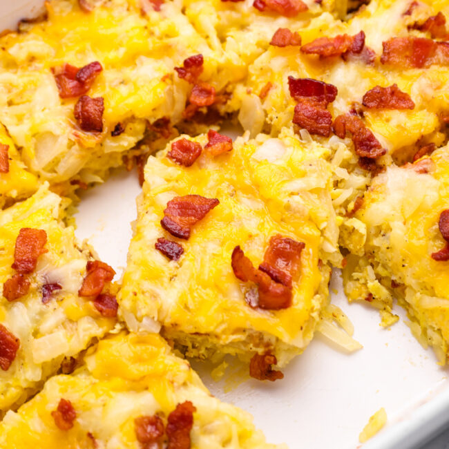 close up on breakfast casserole sliced into squares in a casserole dish