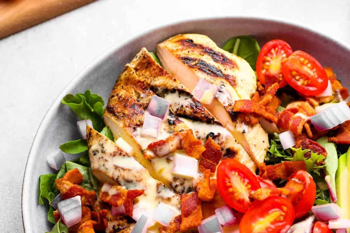 partial view of honey mustard chicken salad in a white bowl.